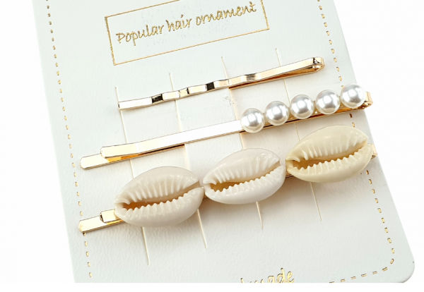 a set of clips with white pearls